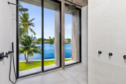 a bathroom with a tub mirror and toilet