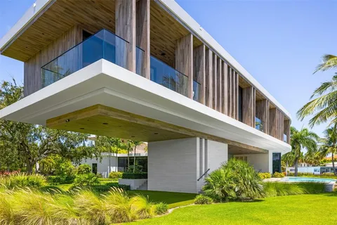 an aerial view of a house with swimming pool outdoor seating and yard