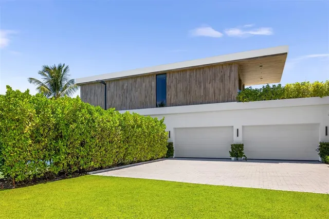 an aerial view of a residential house with outdoor space and swimming pool