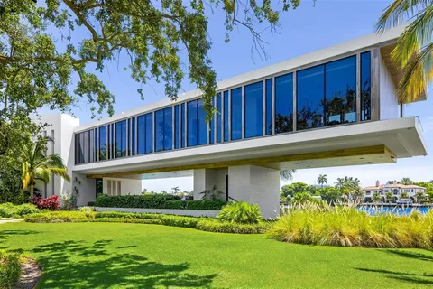a view of house with swimming pool and a yard
