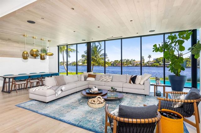 a living room with furniture and a floor to ceiling window