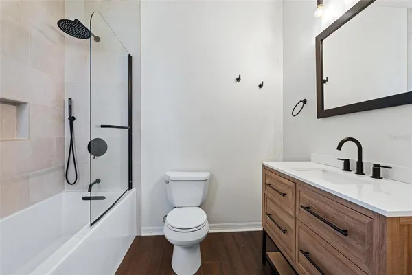 a bathroom with a double vanity sink mirror and bathtub