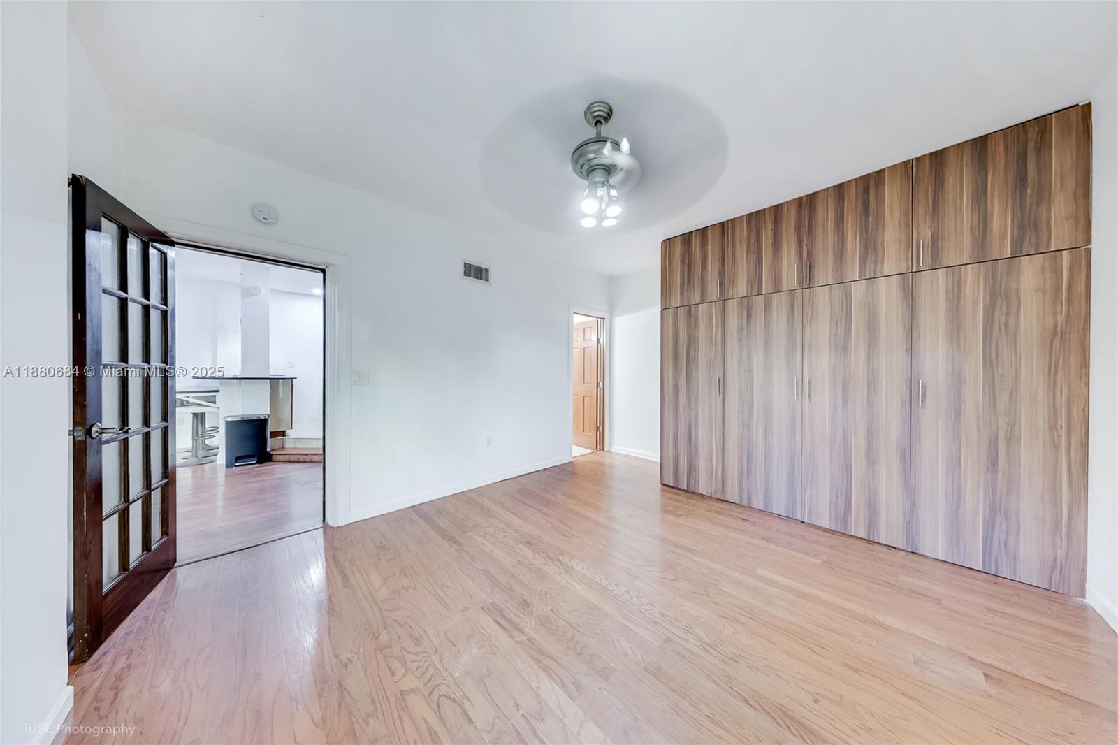 536 14th Street, Unit 110 Miami Beach, FL 33139 - Photo 14 of 15 a view of a big room with wooden floor and a cabinet