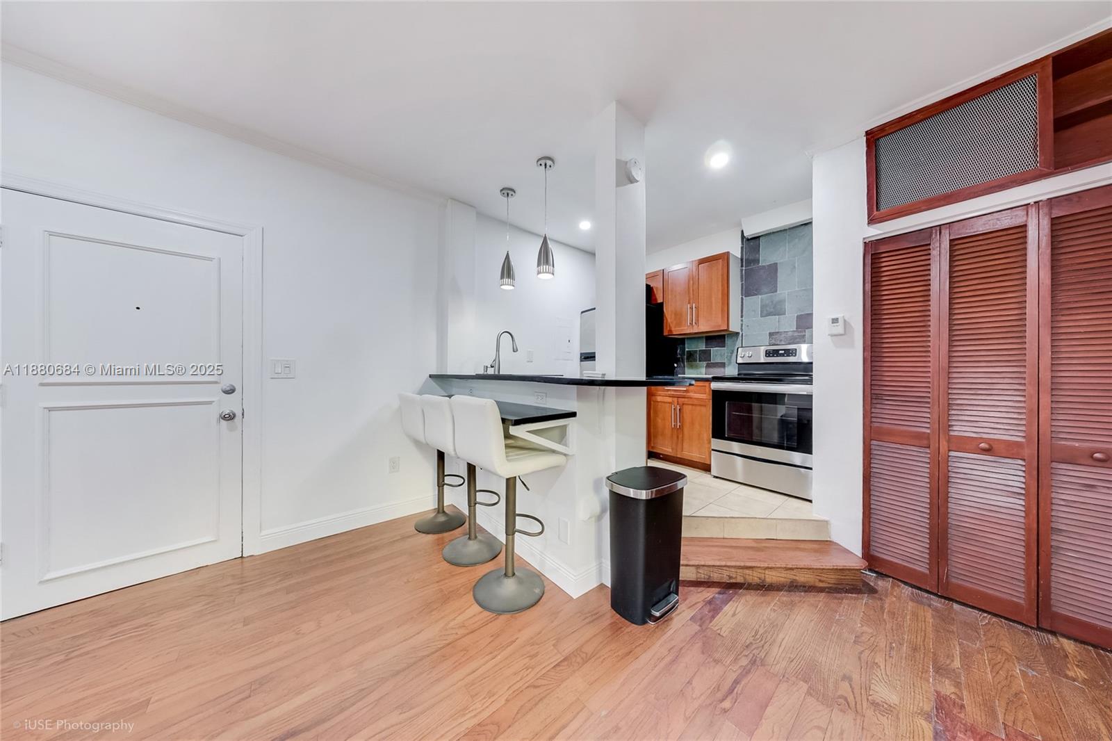 536 14th Street, Unit 110 Miami Beach, FL 33139 - Photo 2 of 15 a kitchen with a refrigerator and a table