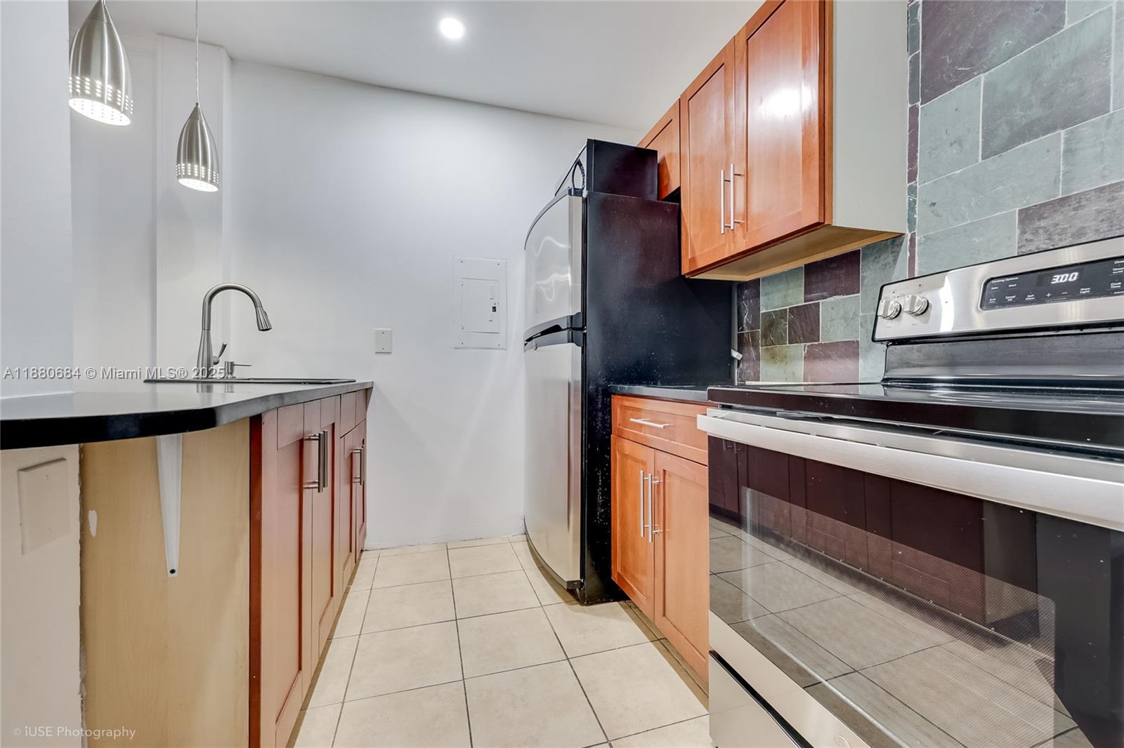536 14th Street, Unit 110 Miami Beach, FL 33139 - Photo 3 of 15 a kitchen with stainless steel appliances granite countertop a refrigerator and a sink