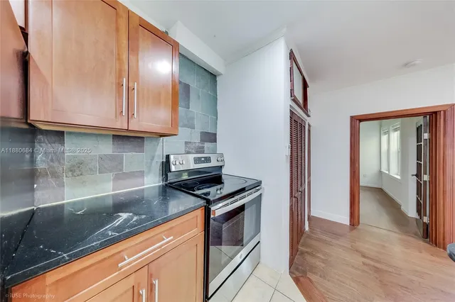 a kitchen with granite countertop a stove and a sink