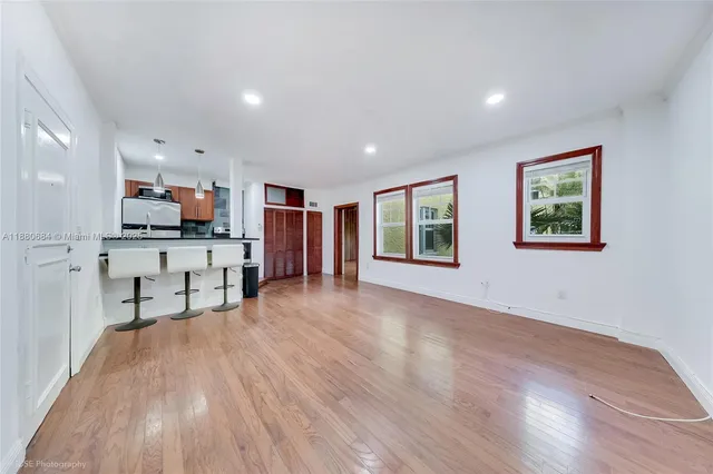 a view of a living room a window and wooden floor
