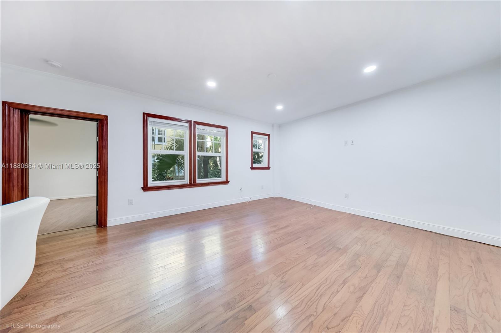 536 14th Street, Unit 110 Miami Beach, FL 33139 - Photo 7 of 15 a view of an empty room with wooden floor and a window