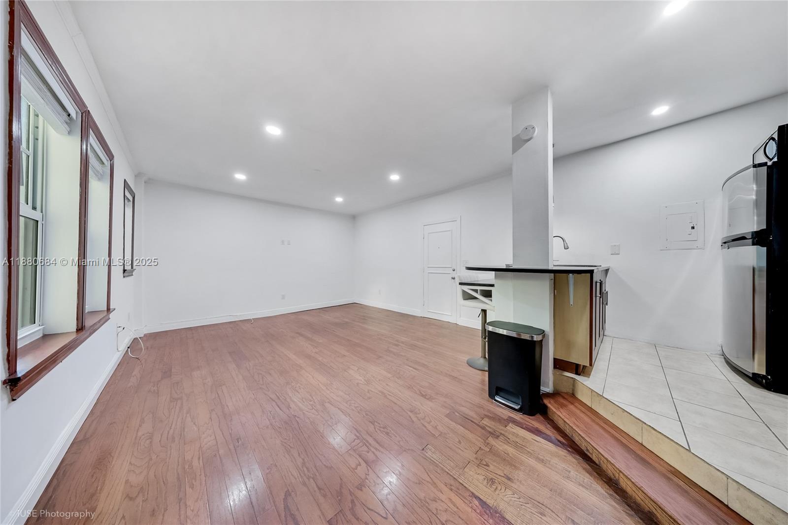 536 14th Street, Unit 110 Miami Beach, FL 33139 - Photo 8 of 15 an empty room with wooden floor and fireplace