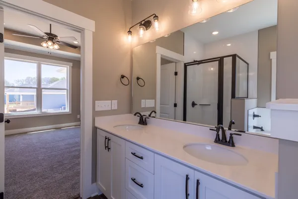 a bathroom with a sink double vanity and a mirror