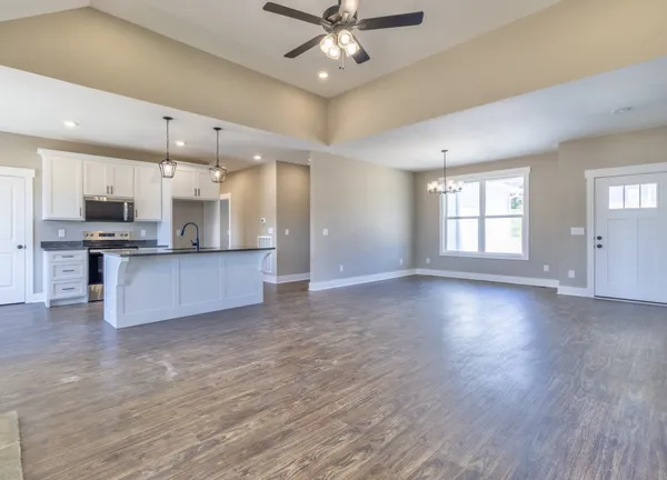 a view of a kitchen with a stove cabinets and wooden floor