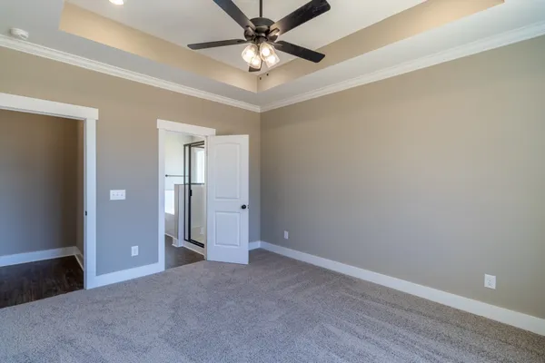 a view of an empty room and a ceiling fan