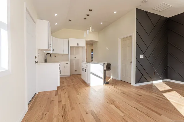 a kitchen with stainless steel appliances a refrigerator and a stove top oven