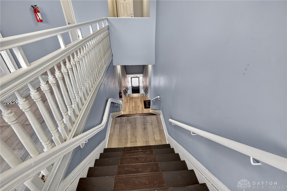 7045-7049 Montgomery Road Cincinnati, OH 45236 - Photo 21 of 68 Navigate this charming staircase featuring a unique blend of wood and classic balusters.