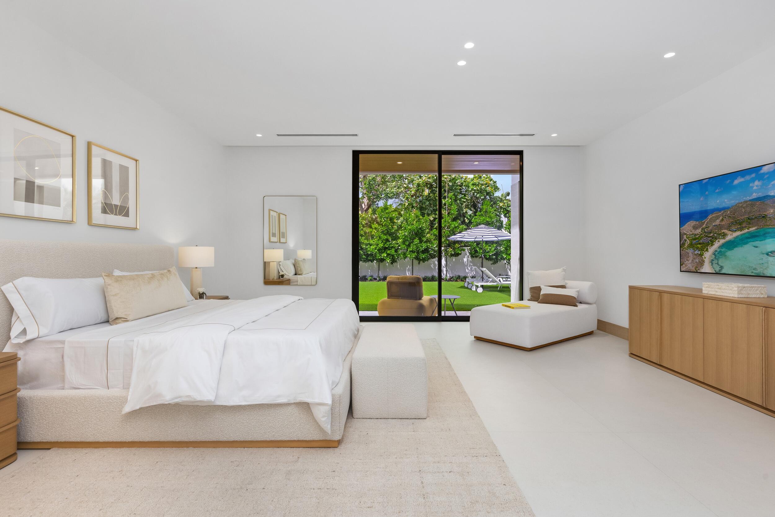 1351 Cocoanut Road Boca Raton, FL 33432 - Photo 82 of 101 a spacious bedroom with a bed and a large window