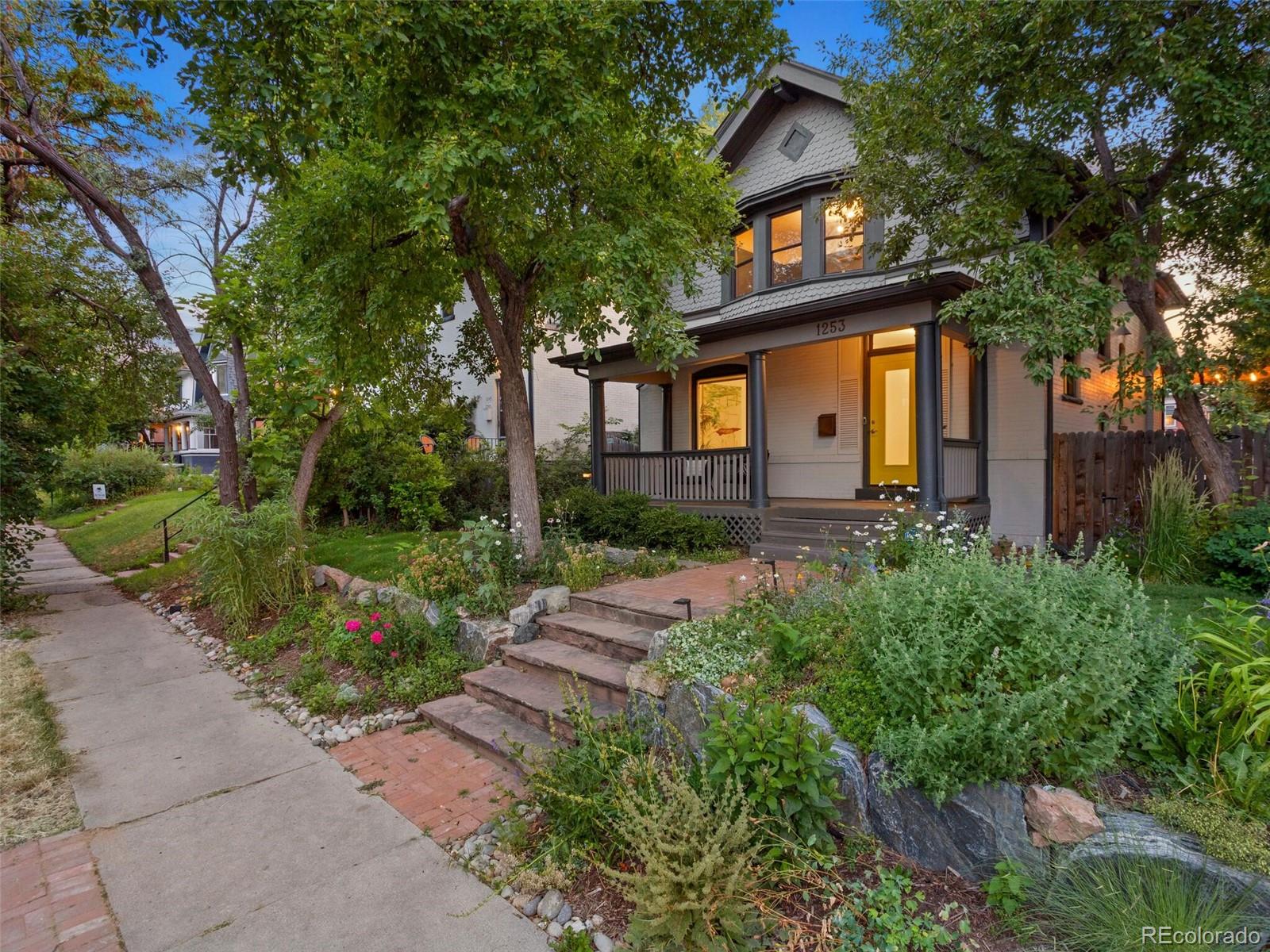1253 Elizabeth Street Denver, CO 80206 - Photo 2 of 49 a front view of a house with garden