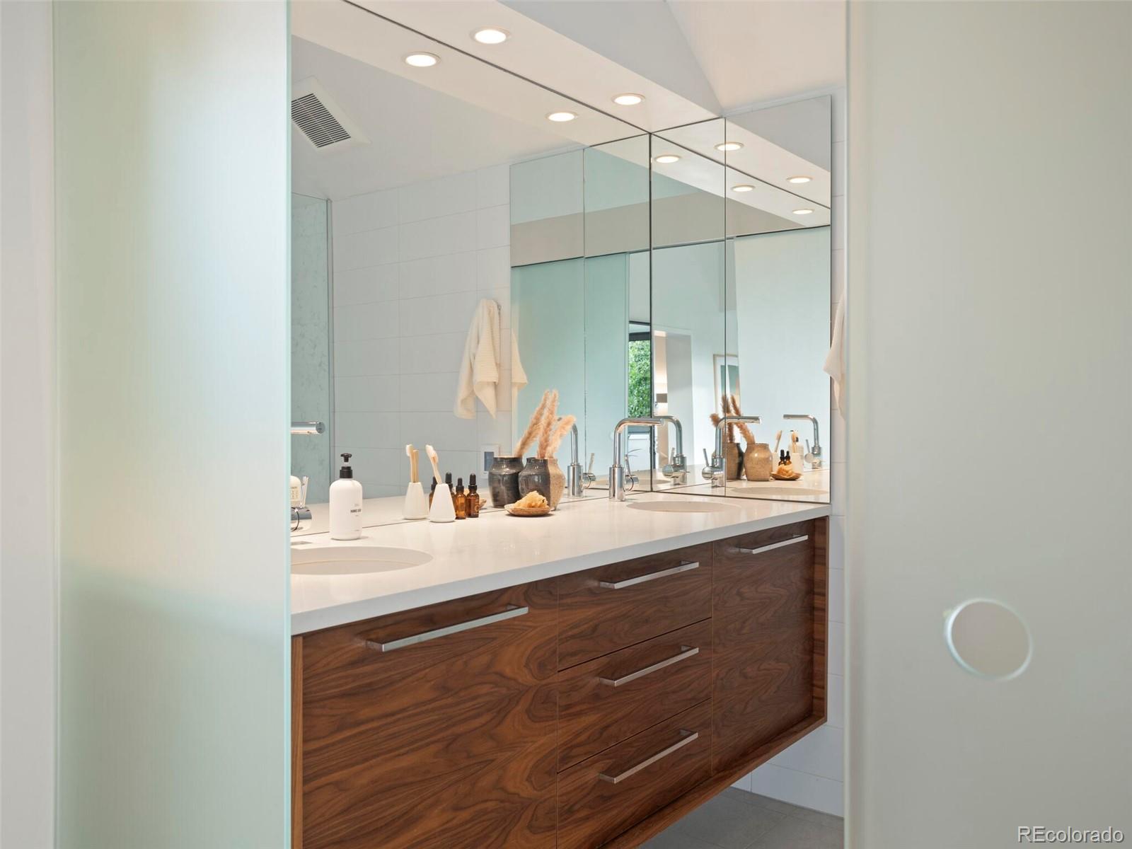 1253 Elizabeth Street Denver, CO 80206 - Photo 26 of 49 a bathroom with a sink vanity granite and a mirror