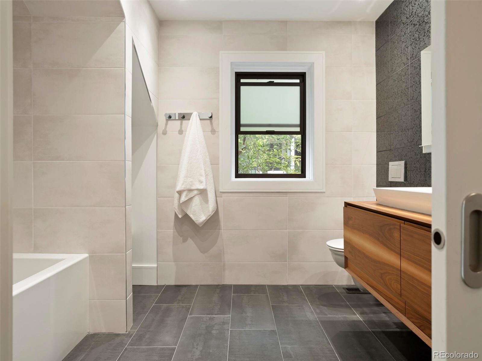 1253 Elizabeth Street Denver, CO 80206 - Photo 32 of 49 a bathroom with a shower