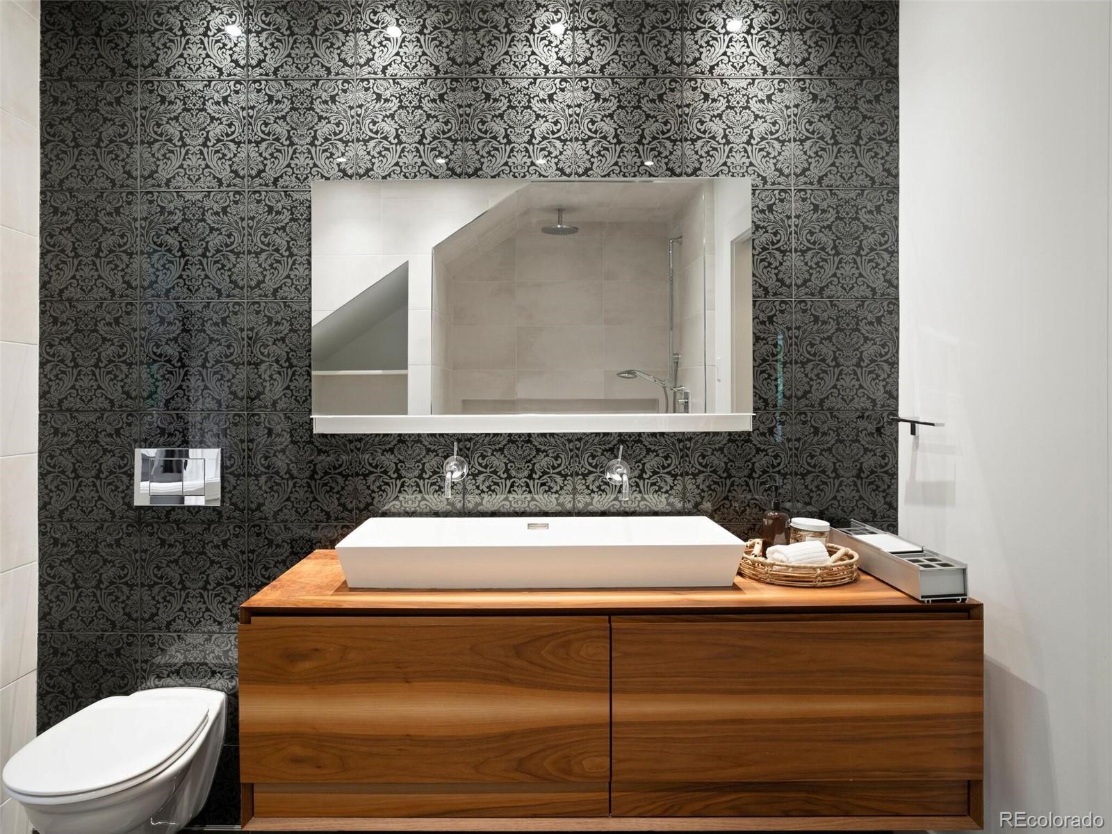 1253 Elizabeth Street Denver, CO 80206 - Photo 33 of 49 a bathroom with a toilet sink and mirror