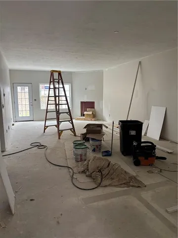 a room with a couch and white walls