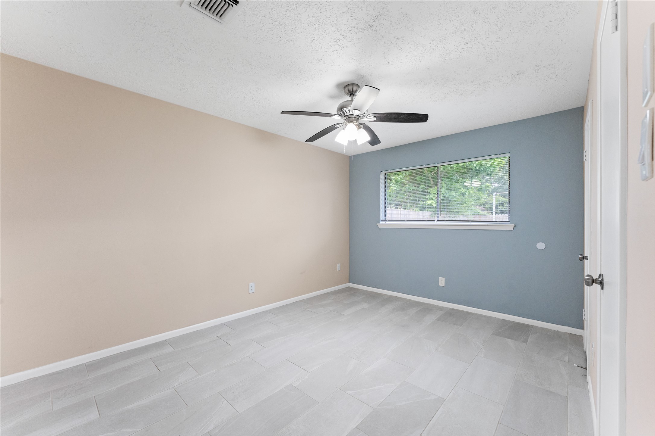 1431 Epsilon Street Pasadena, TX 77504 - Photo 13 of 21 an empty room with a window and a fan