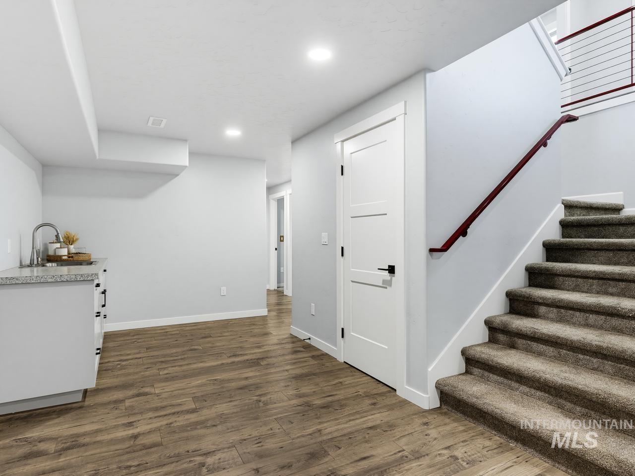 4950 West Columbia Road Nampa, ID 83687 - Photo 30 of 50 Lower level featuring wood-finish flooring, a built-in wet bar with a countertop and undermount sink, and recessed lighting