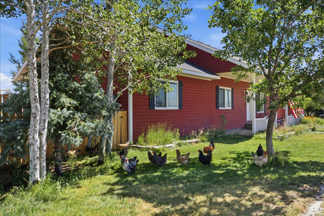 1634 West Arimo Road Arimo, ID 83214 - Photo 87 of 89 Red exterior siding with white trim and dark window shutters