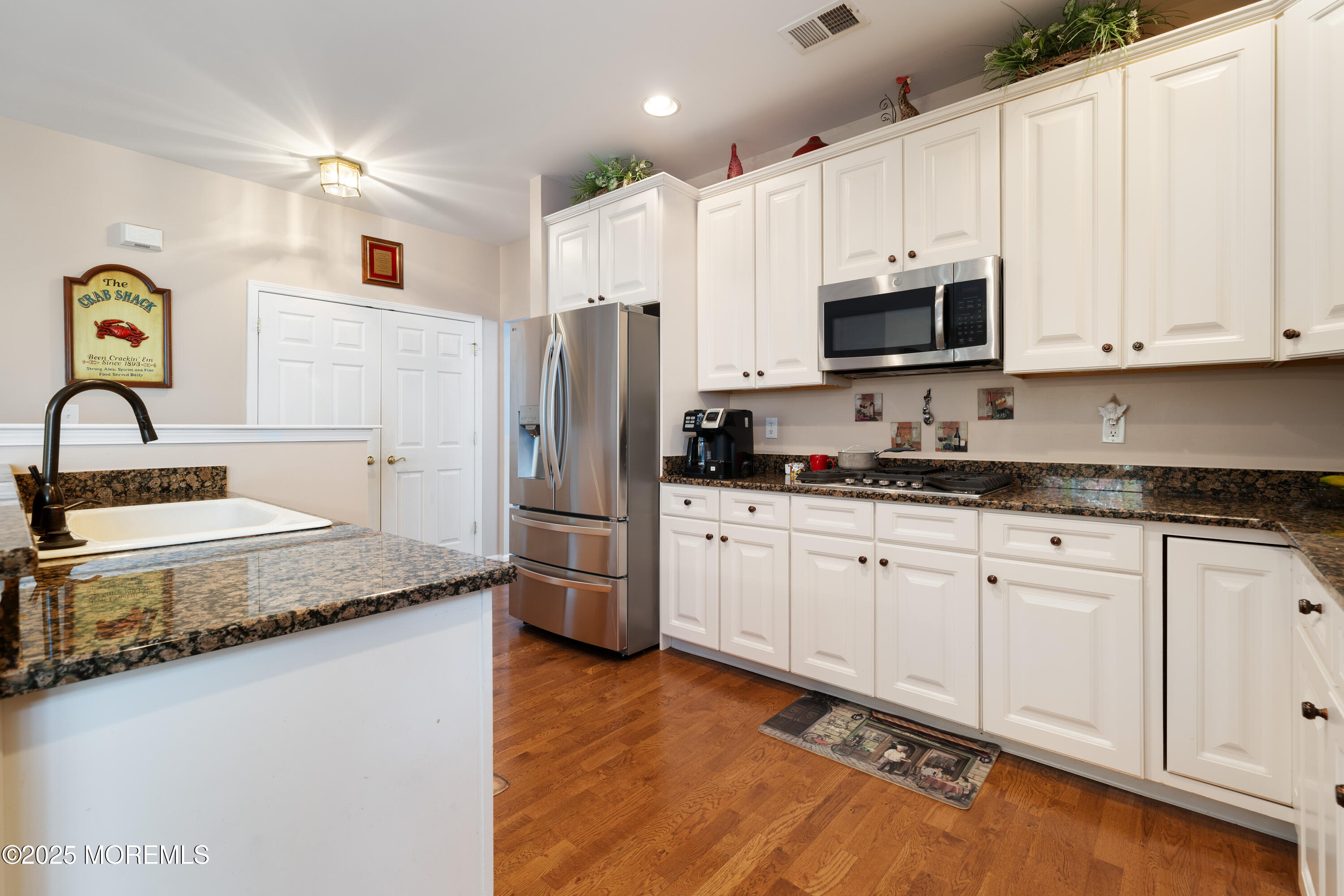 24 Pond View Circle Barnegat, NJ 08005 - Photo 13 of 50 a kitchen with stainless steel appliances granite countertop a refrigerator sink and white cabinets
