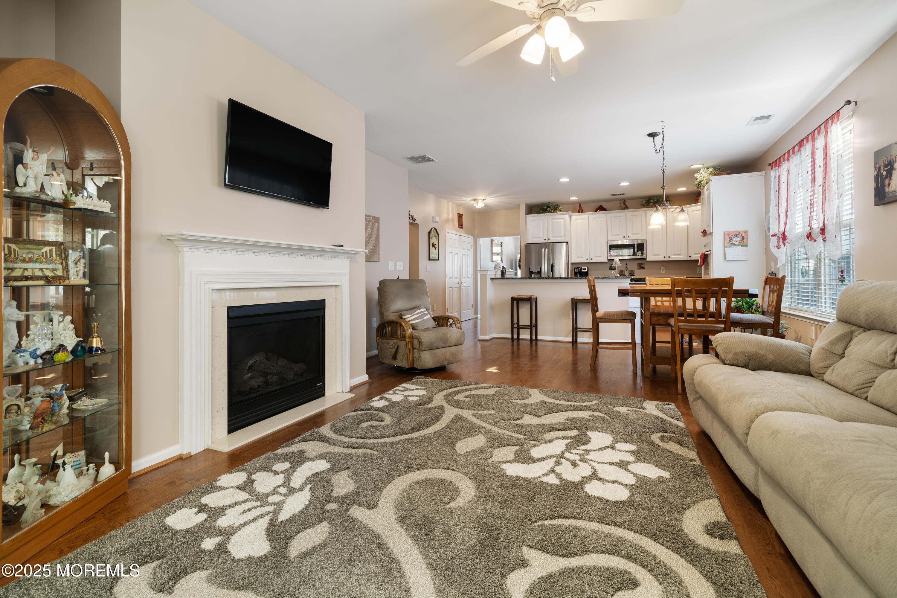 24 Pond View Circle Barnegat, NJ 08005 - Photo 19 of 50 a living room with furniture a flat screen tv and a fireplace