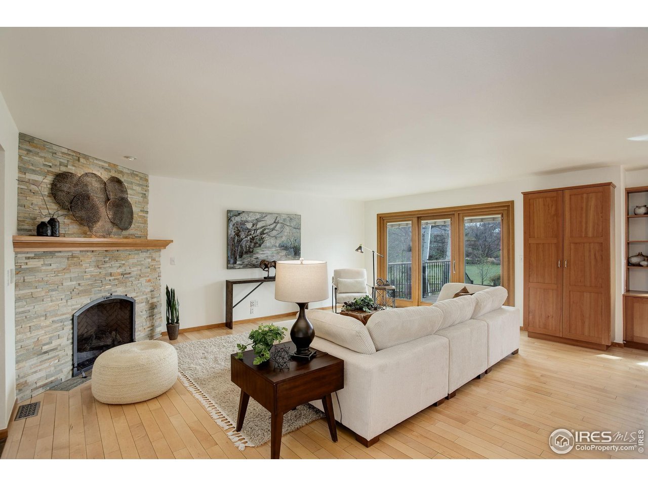4462 Wellington Road Boulder, CO 80301 - Photo 13 of 37 a living room with furniture a fireplace and a large window