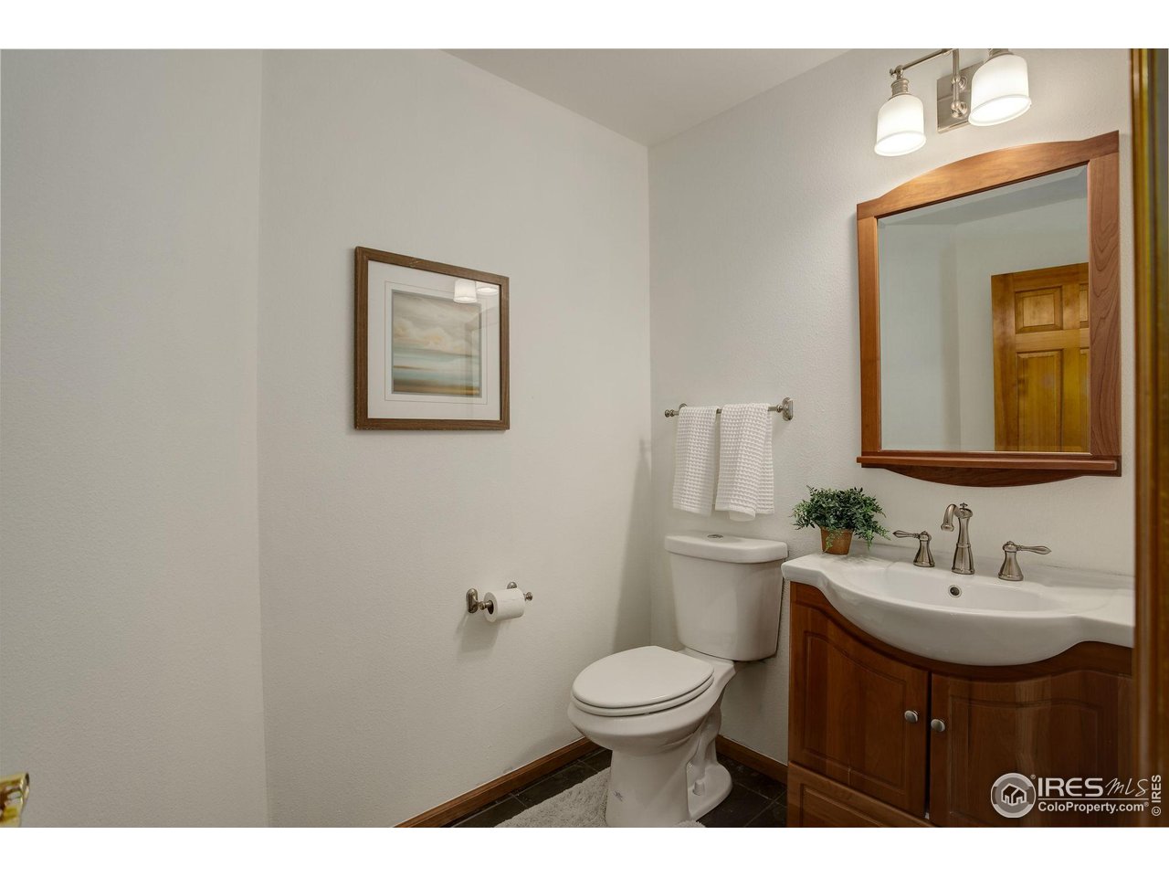4462 Wellington Road Boulder, CO 80301 - Photo 21 of 37 a bathroom with a toilet sink and mirror