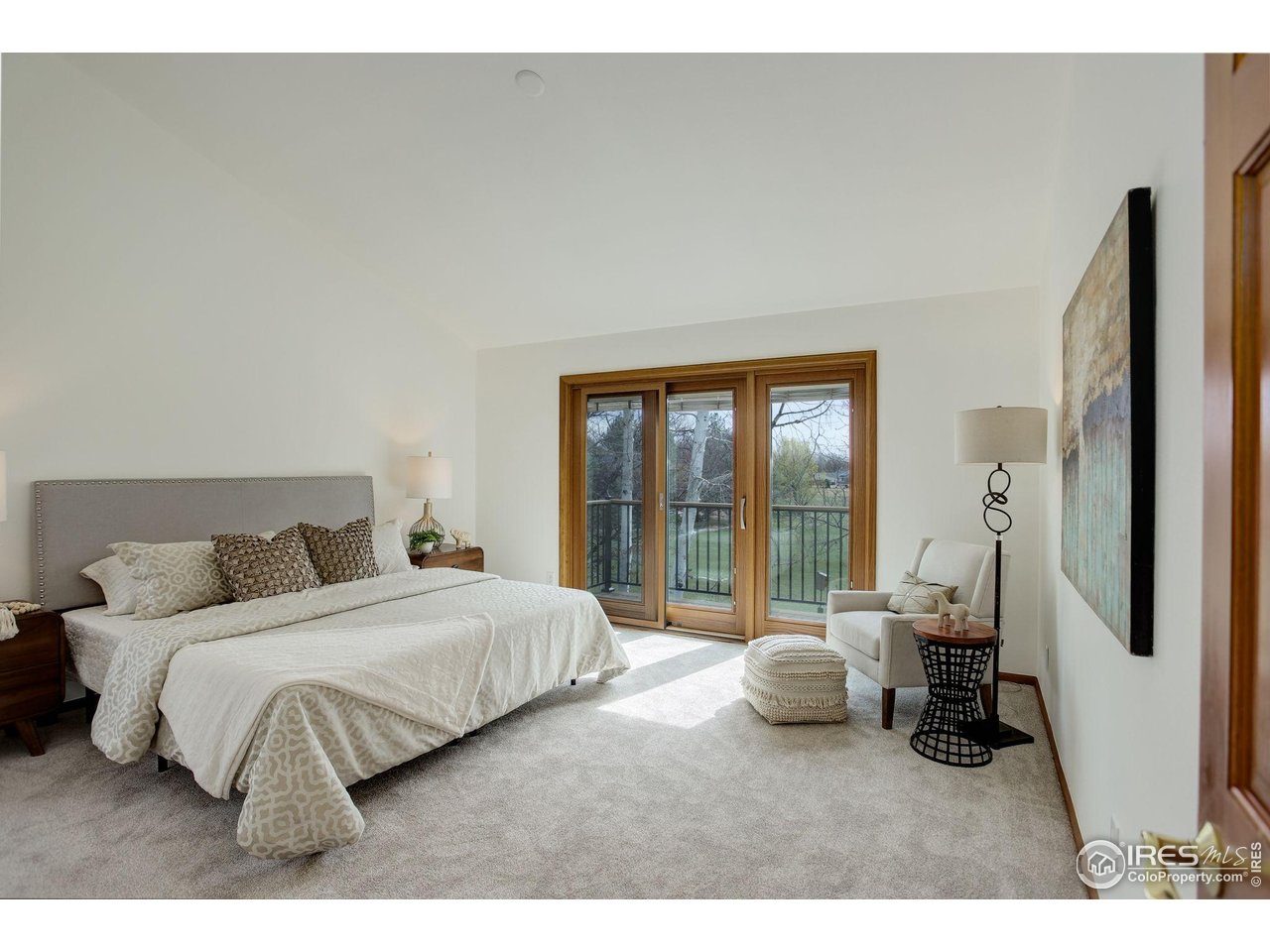 4462 Wellington Road Boulder, CO 80301 - Photo 22 of 37 a bedroom with a bed and glass door