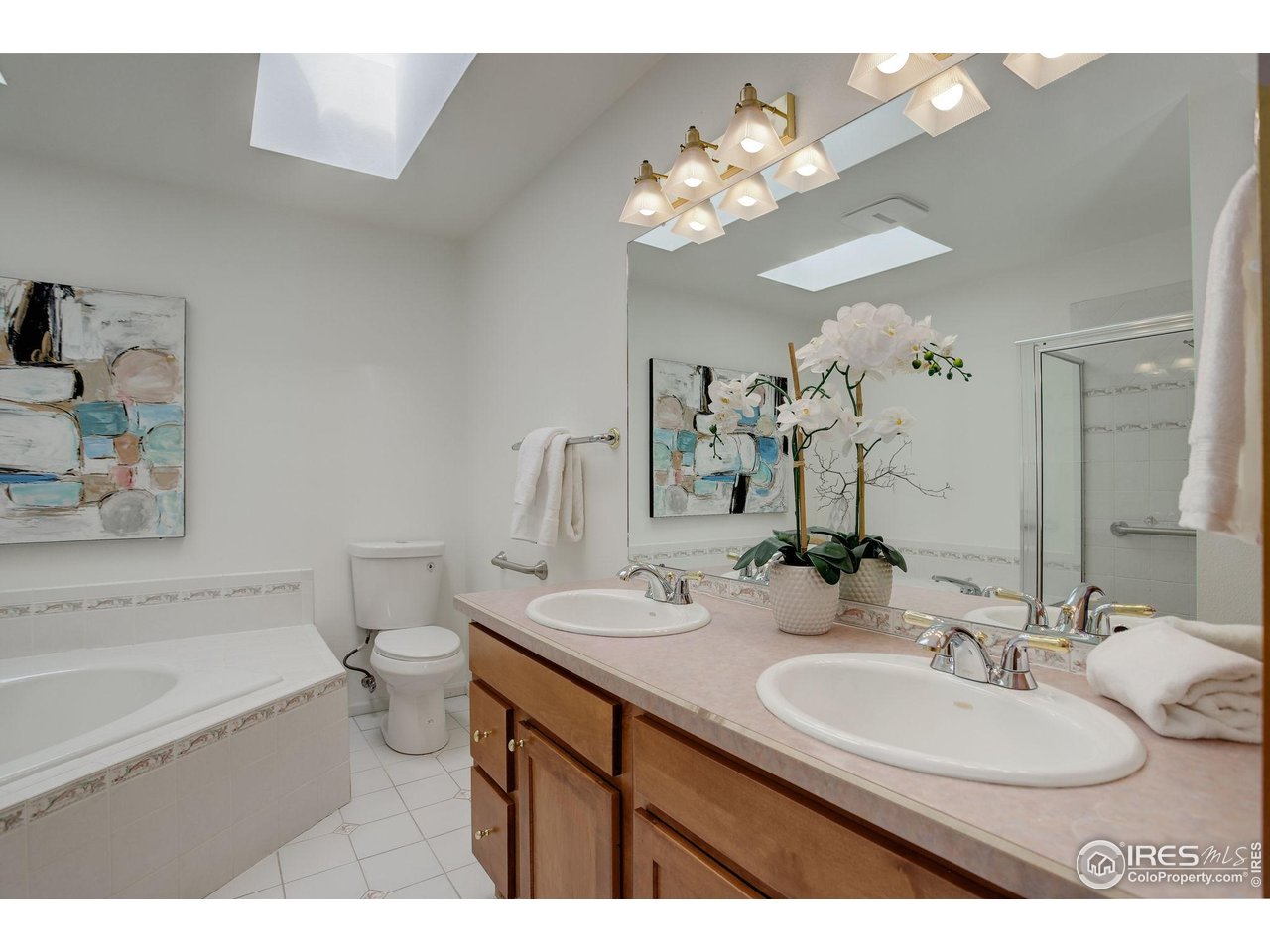 4462 Wellington Road Boulder, CO 80301 - Photo 25 of 37 a bathroom with a sink a toilet and a mirror