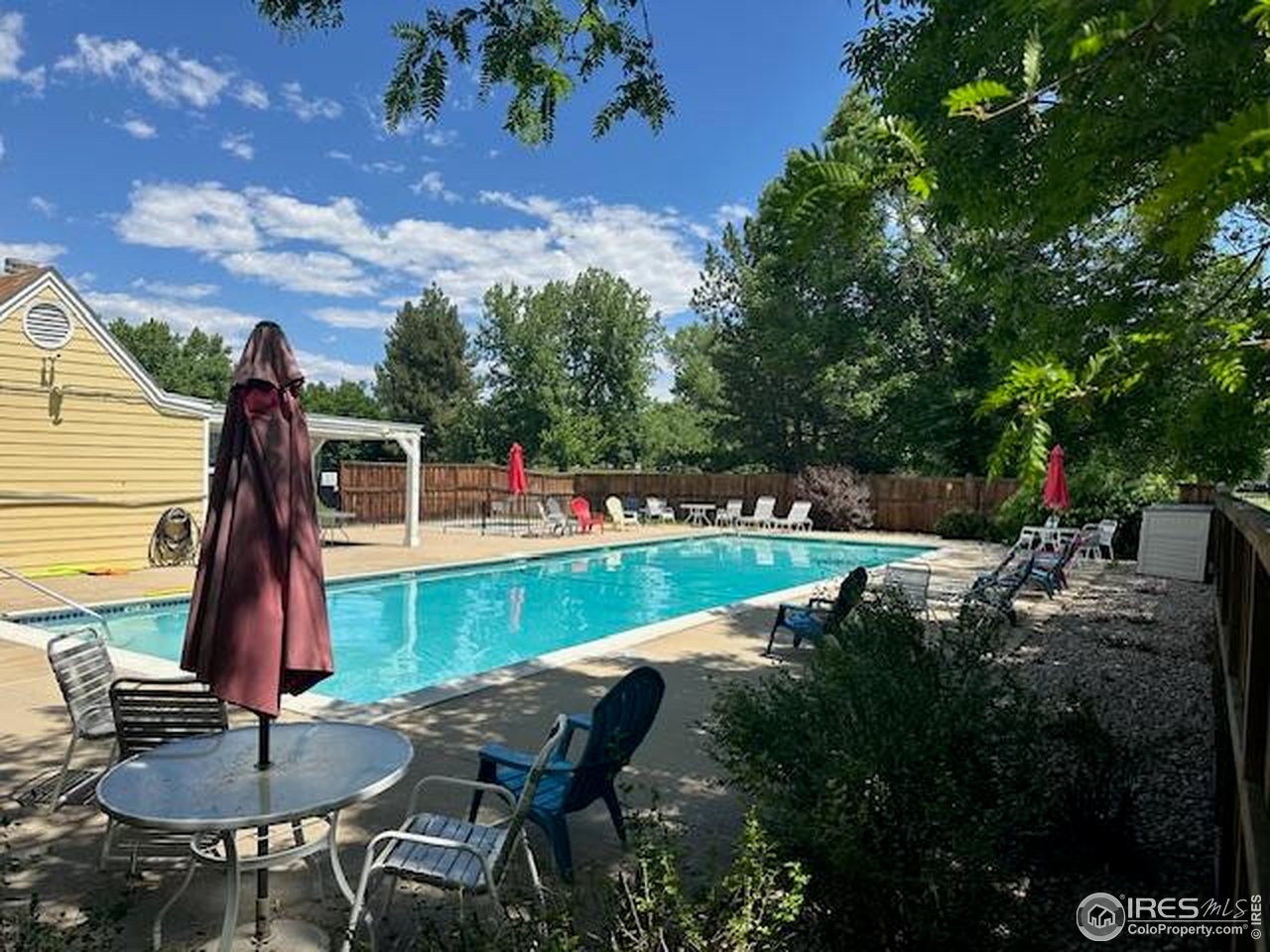4462 Wellington Road Boulder, CO 80301 - Photo 33 of 37 a view of backyard with table and chairs and wooden fence