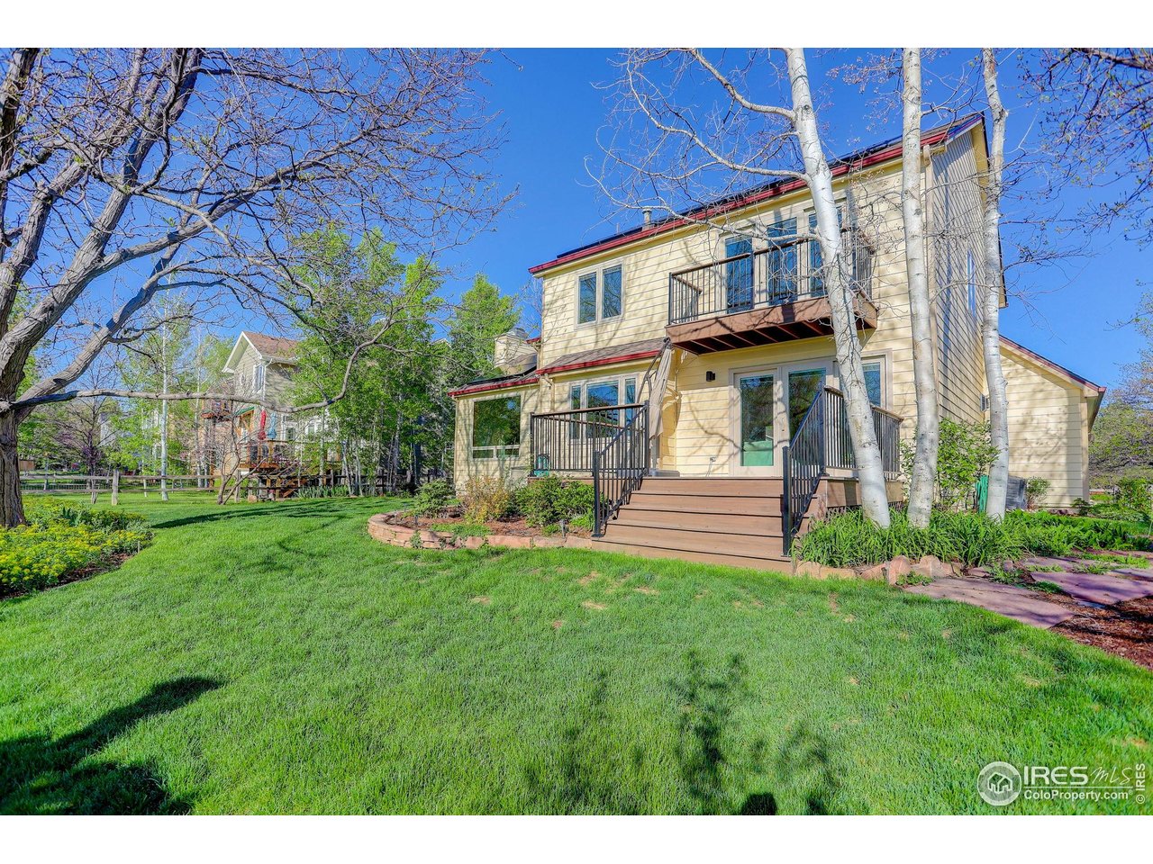 4462 Wellington Road Boulder, CO 80301 - Photo 7 of 37 a view of a house with a big yard potted plants and large tree