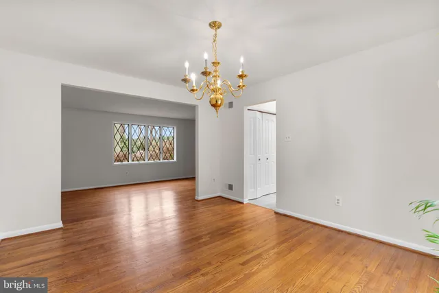 a kitchen with stainless steel appliances a table chairs stove and refrigerator