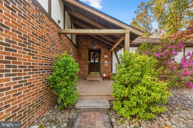 a living room with furniture wooden floor and a fireplace