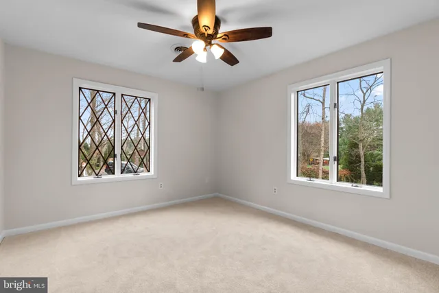 a view of a swimming pool with a patio and a yard