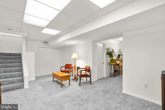 a front view of a house with a garden and trees