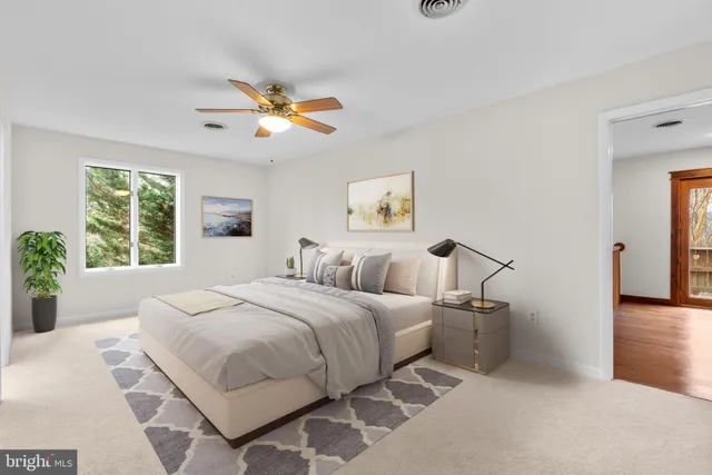 an empty room with wooden floor cabinet and windows