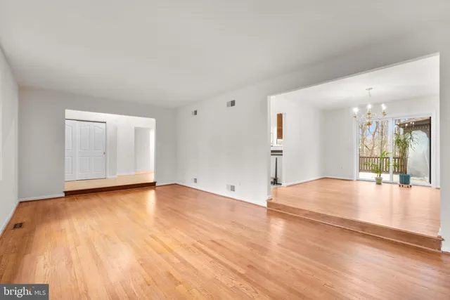 a kitchen with kitchen island granite countertop a sink a counter space stainless steel appliances and cabinets