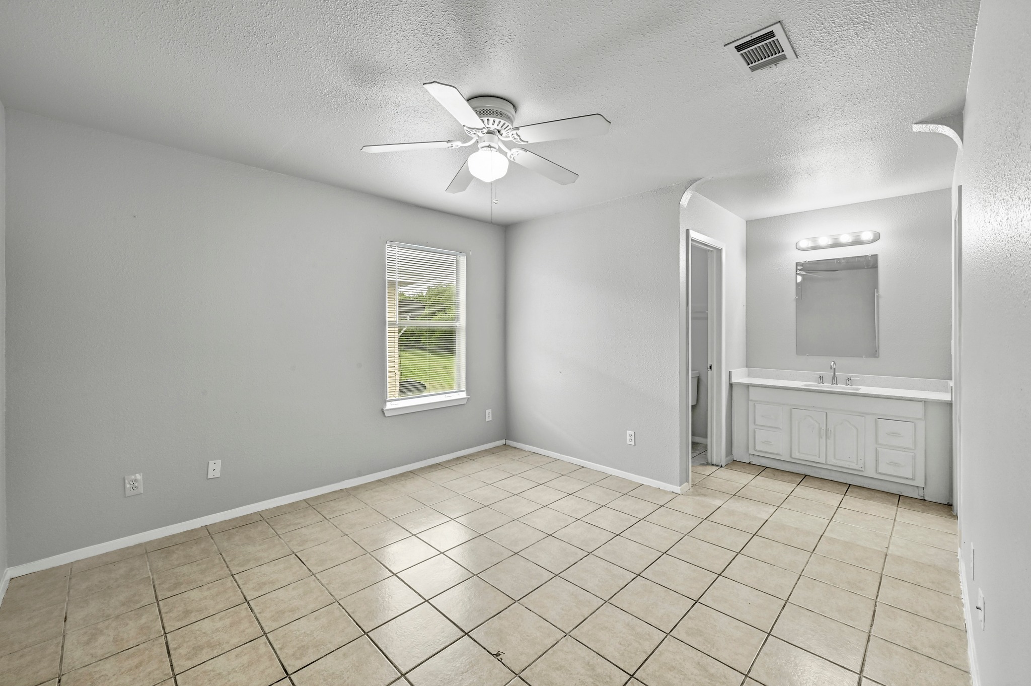 2212 Katy Lane Georgetown, TX 78626 - Photo 16 of 27 Spacious room featuring neutral-toned tile flooring, a window offering views of the outdoors, and a ceiling fan