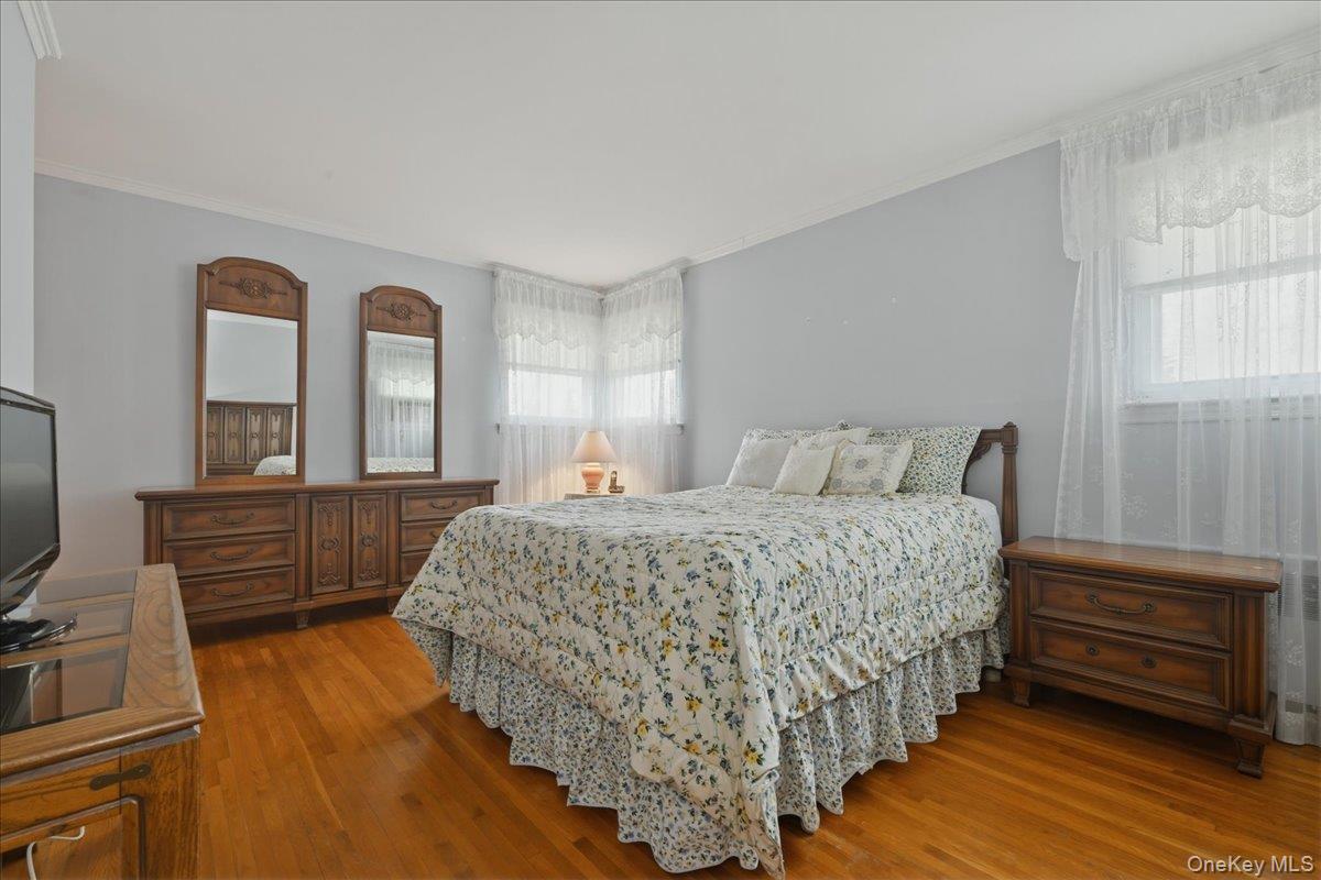 17 Avon Road Farmingdale, NY 11735 - Photo 17 of 46 a bedroom with a bed and a flat tv screen on dresser