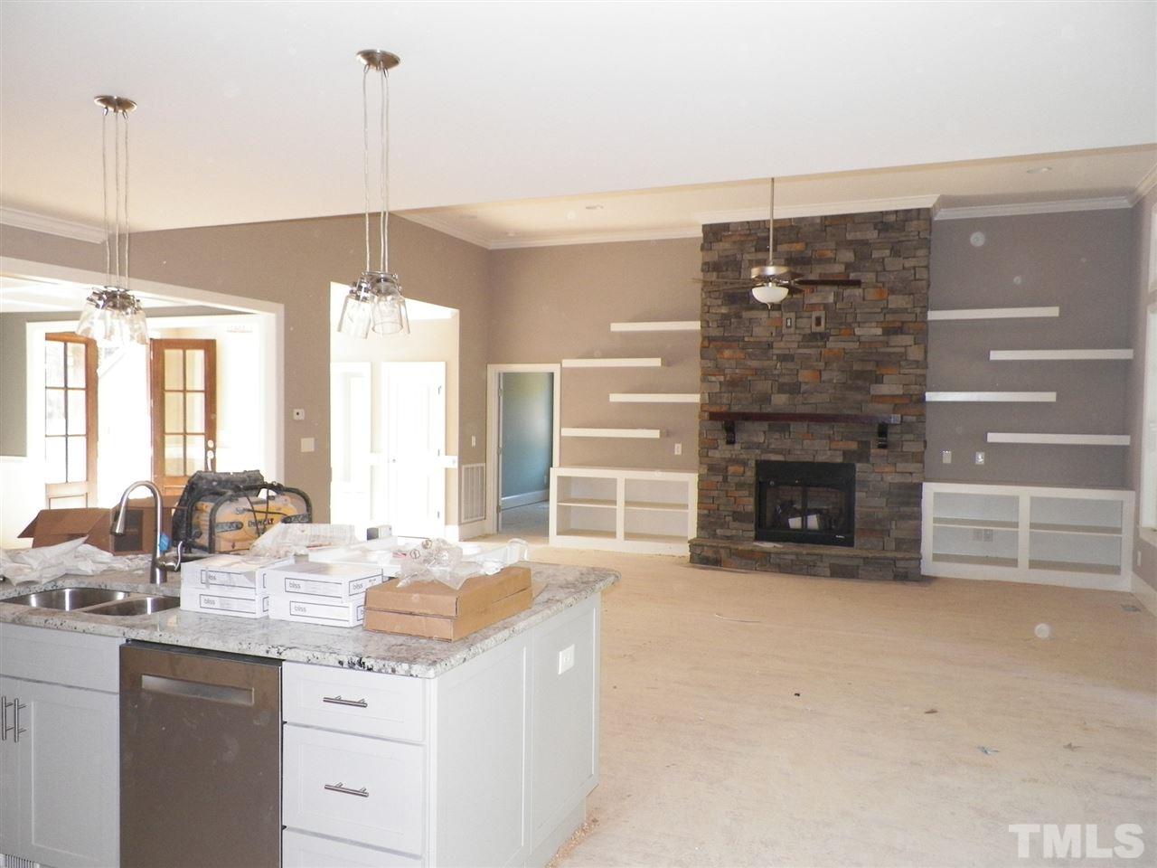 6113 Spring Branch Circle Raleigh, NC 27603 - Photo 11 of 22 a kitchen with a sink and a fireplace