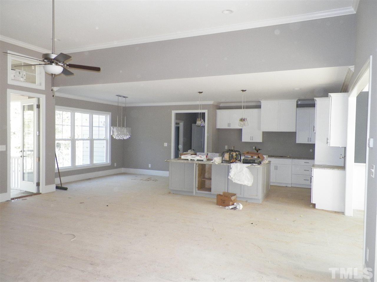 6113 Spring Branch Circle Raleigh, NC 27603 - Photo 12 of 22 a large white kitchen with a large window a sink and stainless steel appliances