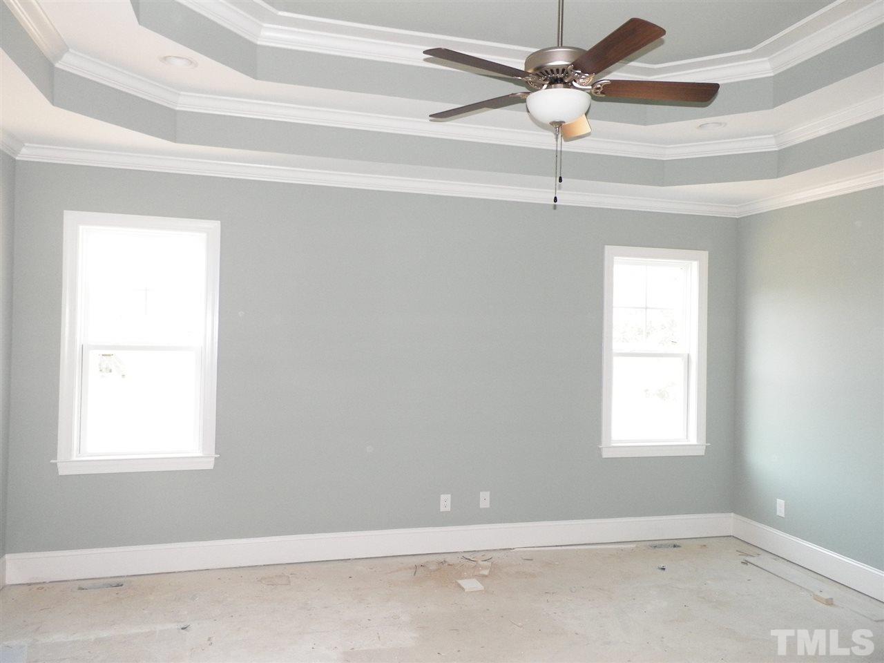 6113 Spring Branch Circle Raleigh, NC 27603 - Photo 14 of 22 an empty room with windows and fan
