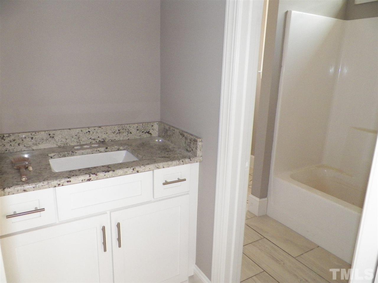6113 Spring Branch Circle Raleigh, NC 27603 - Photo 18 of 22 a bathroom with a sink and a shower