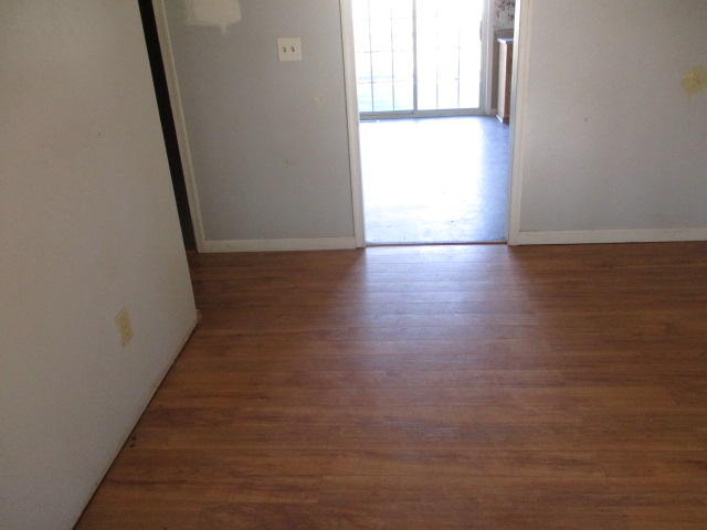 9739 Stewartsville Road Goodview, VA 24095 - Photo 3 of 11 a view of a hallway with wooden floor