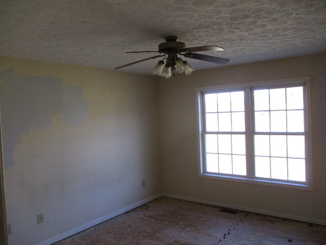 9739 Stewartsville Road Goodview, VA 24095 - Photo 5 of 11 an empty room with a window