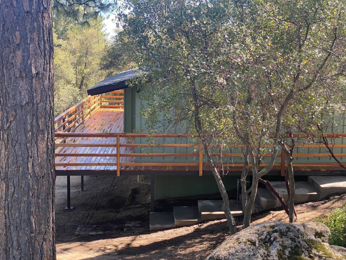 53551 West Ridge Road Idyllwild, CA 92549 - Photo 2 of 33 a view of a balcony with a bench and trees